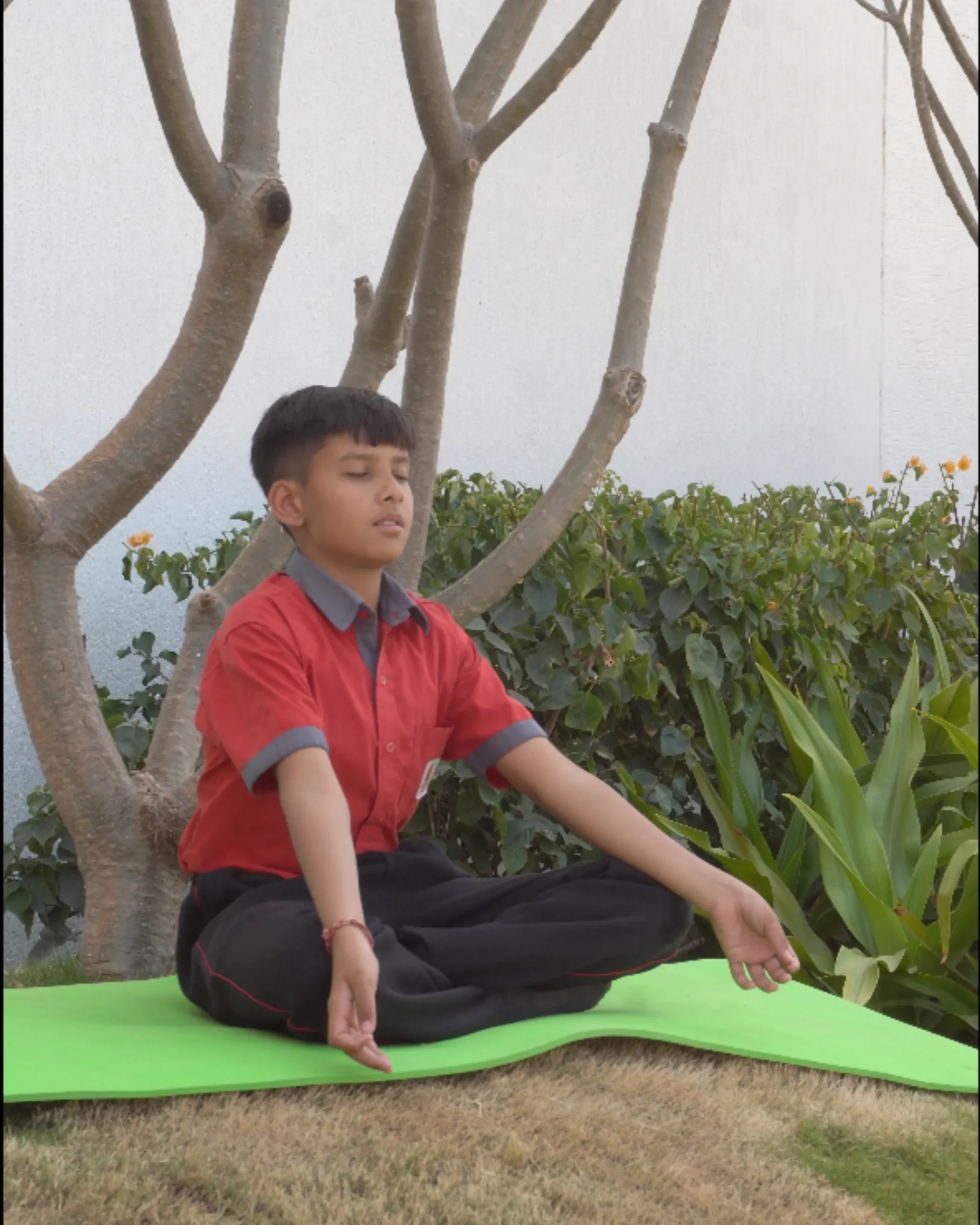 Boy Meditating Outdoors On Yoga Mat