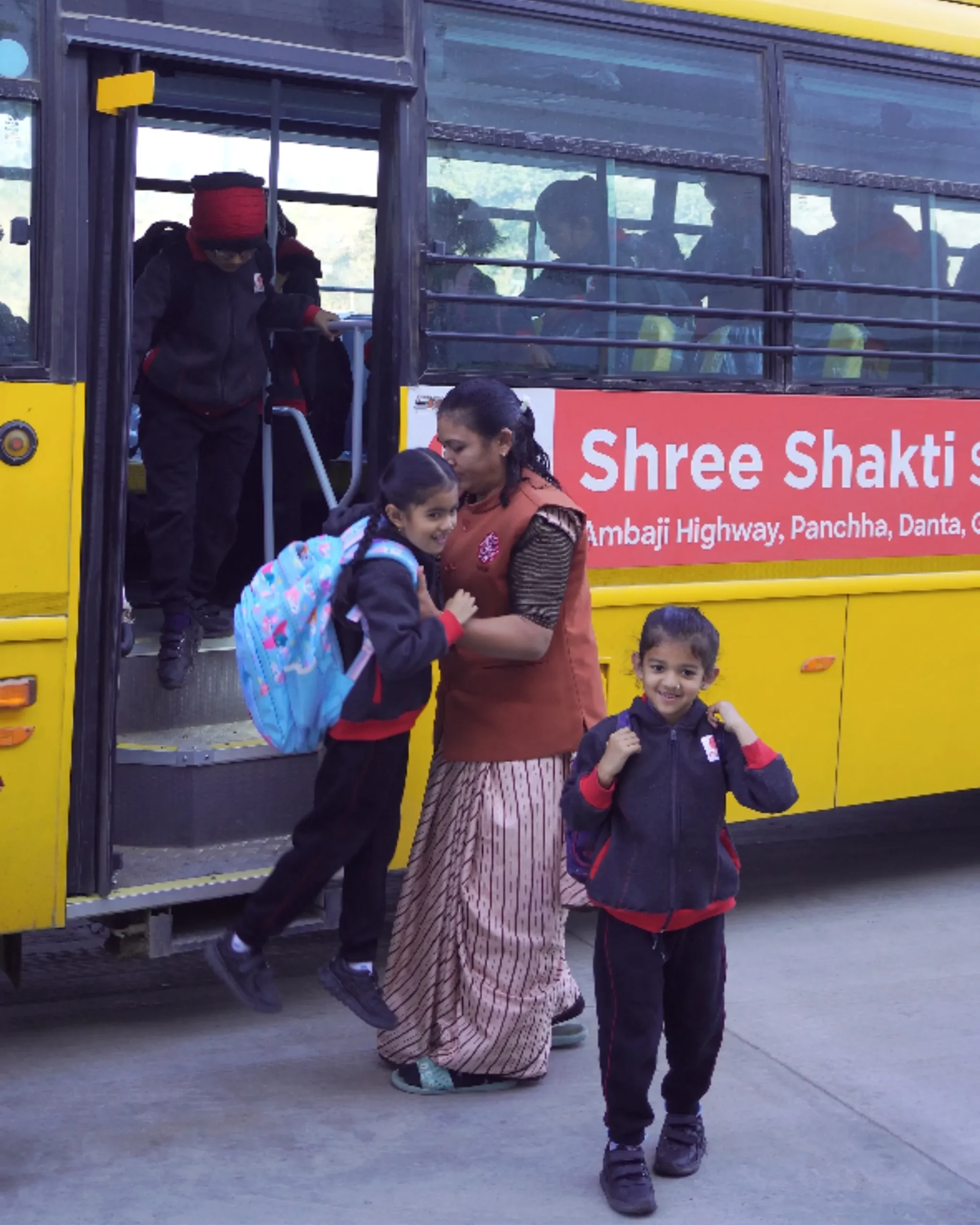 School Children Getting Off Yellow Bus
