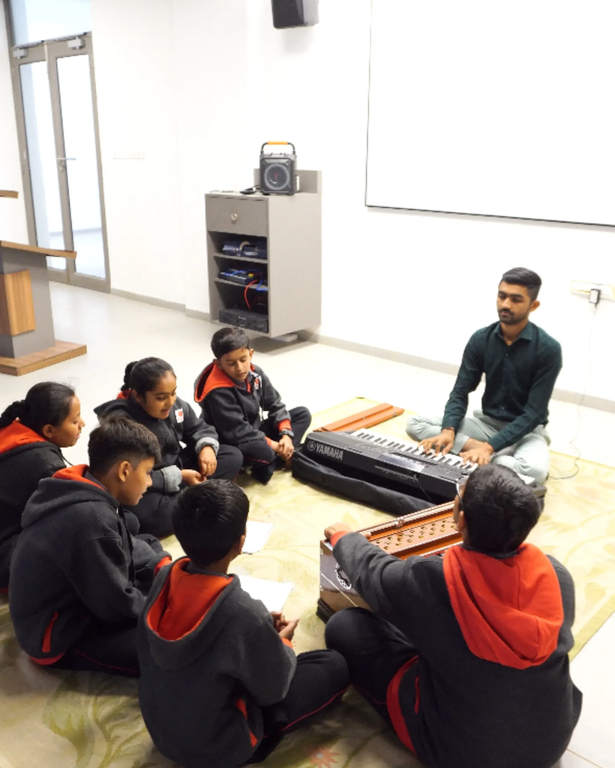 Students Learning Music With Teacher In Classroom