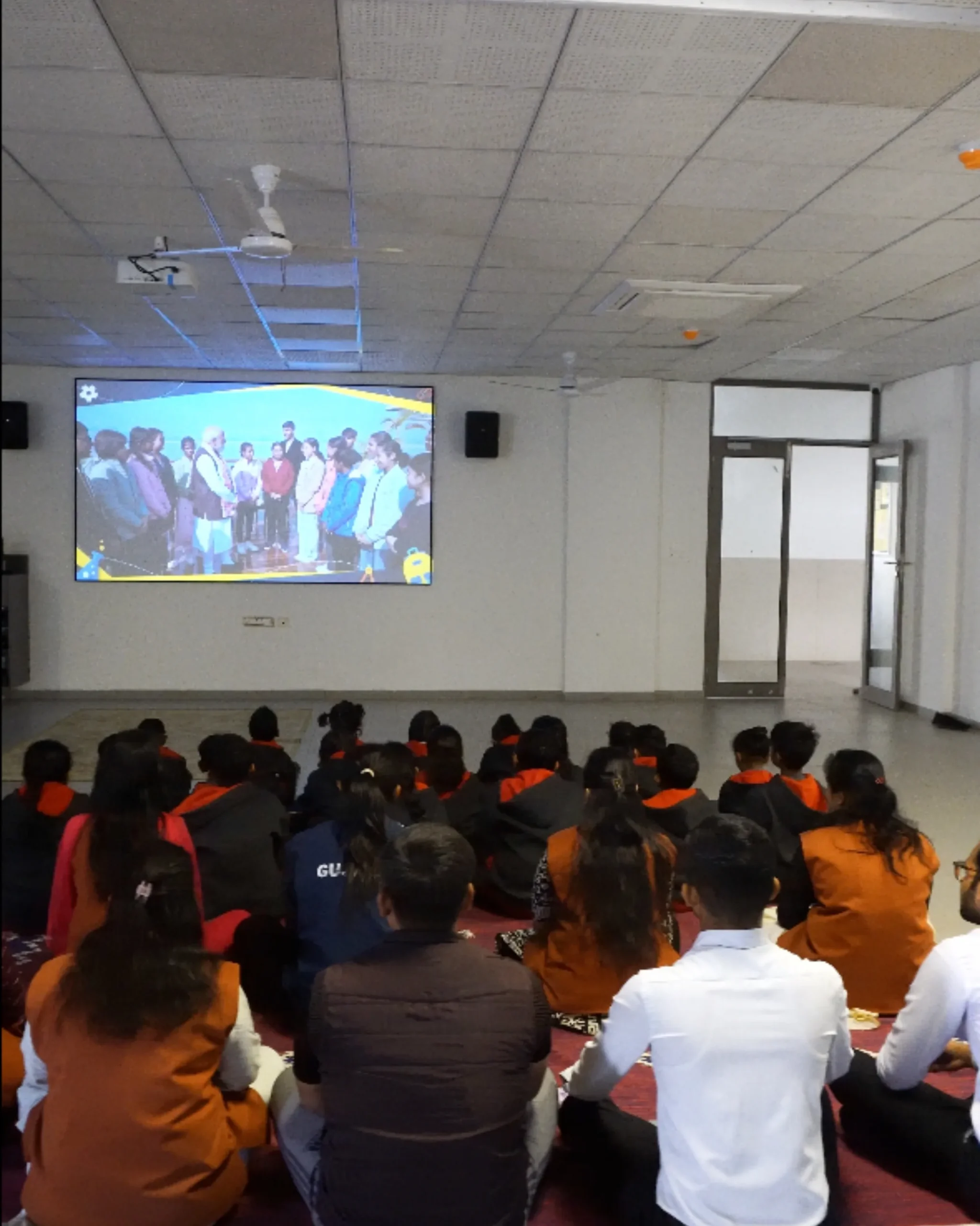 Students Watching Presentation On Large Screen