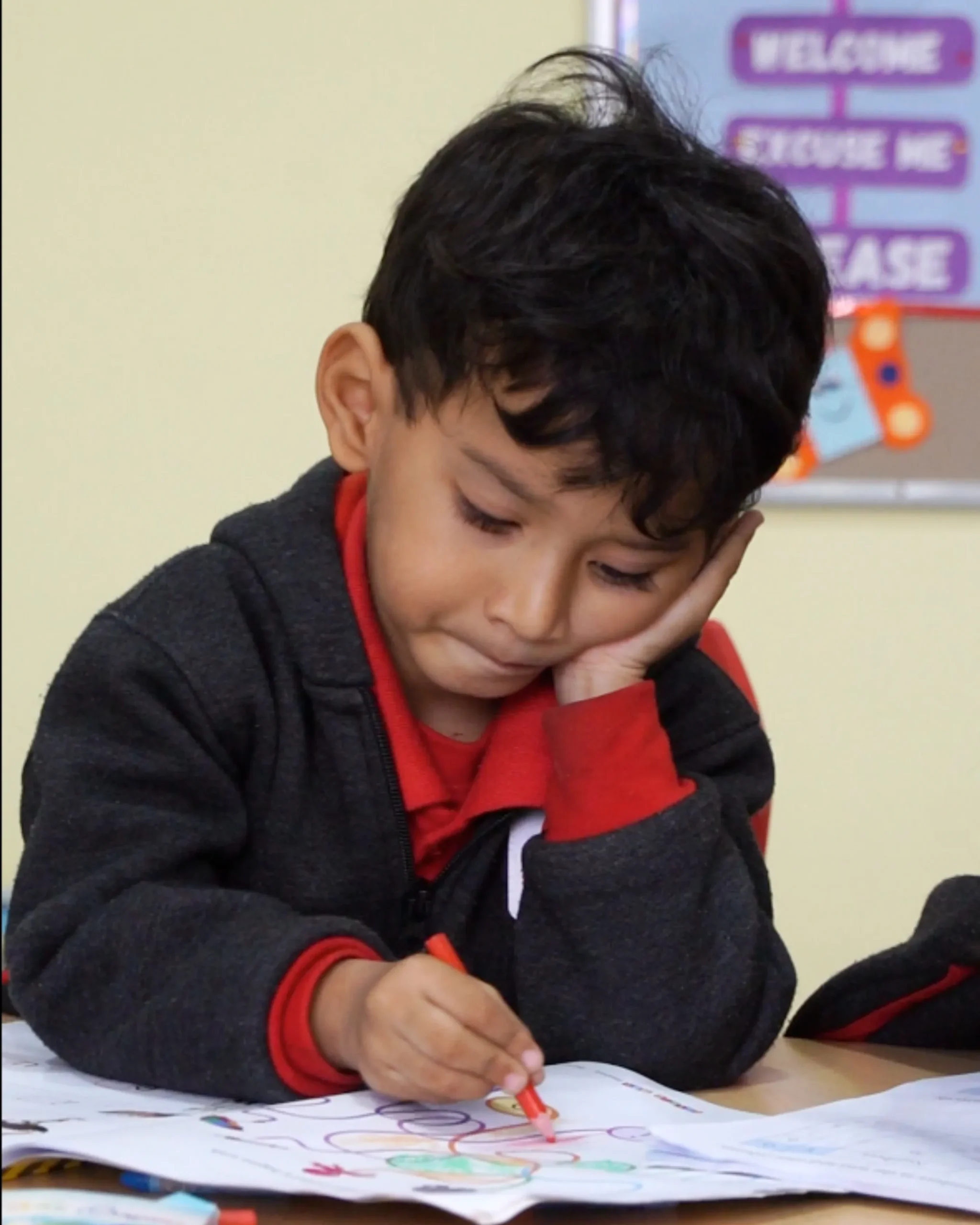 Young Boy Drawing In Classroom