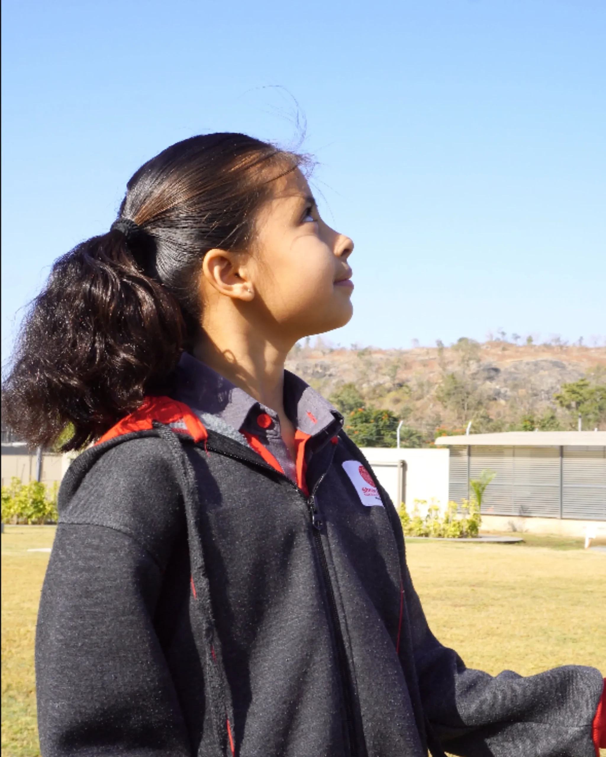 Young Girl Looking Up At Sky