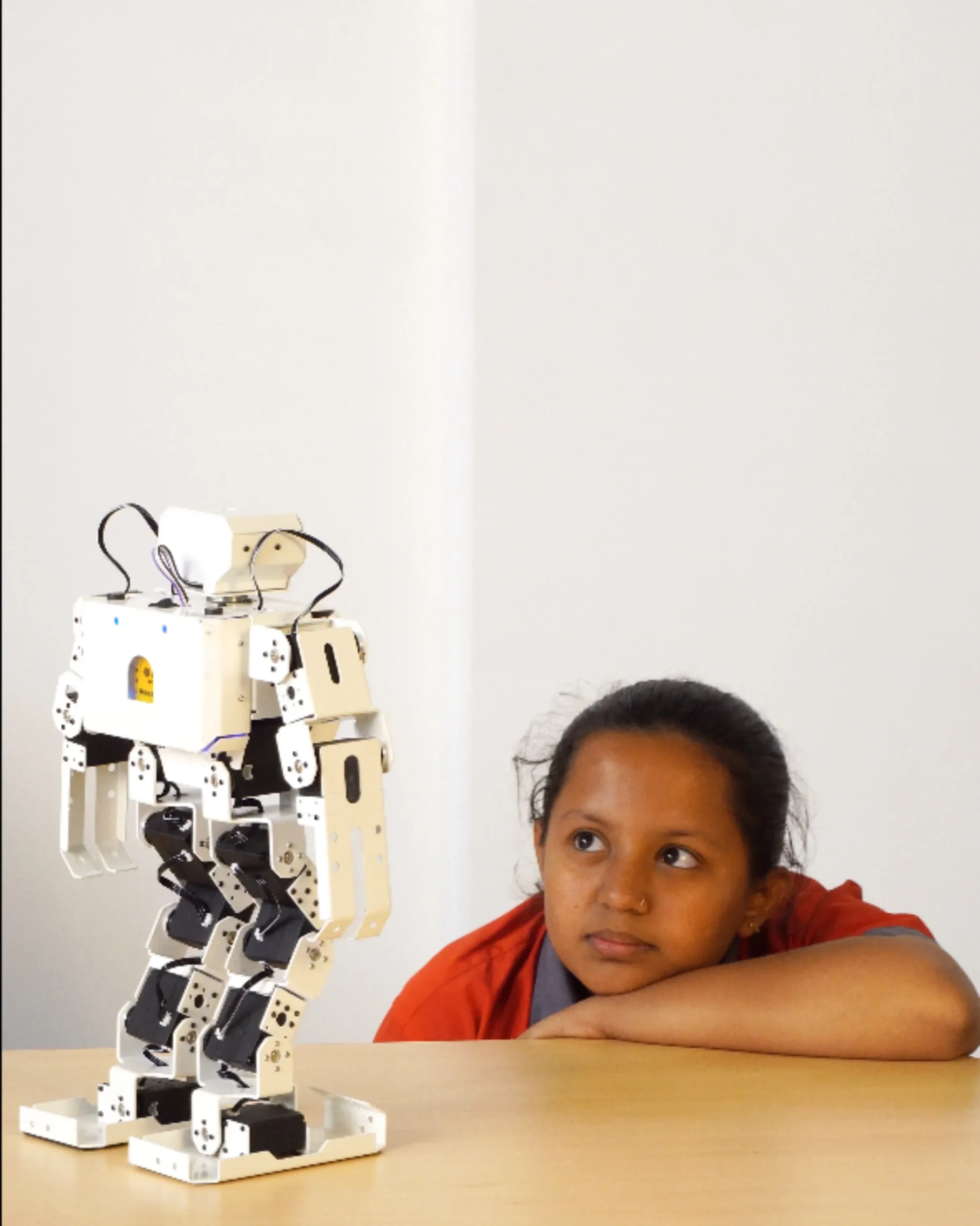 Young Girl Observing Humanoid Robot