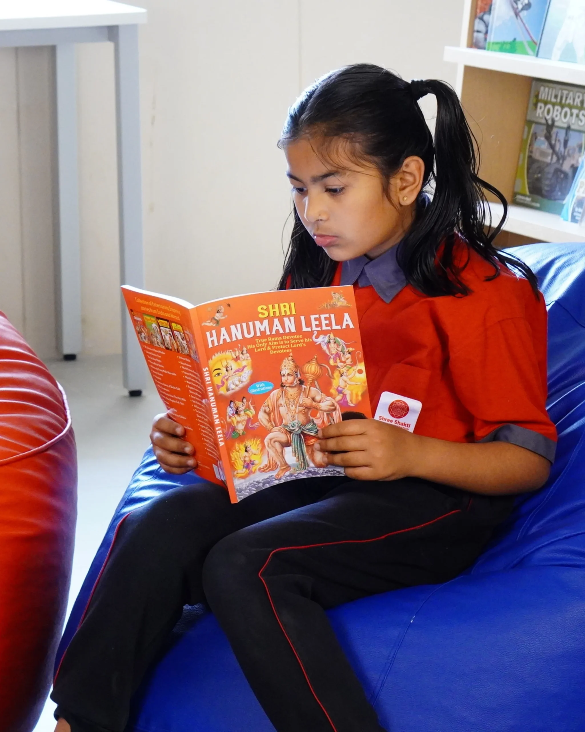 Young Girl Reading Shri Hanuman Leela Book