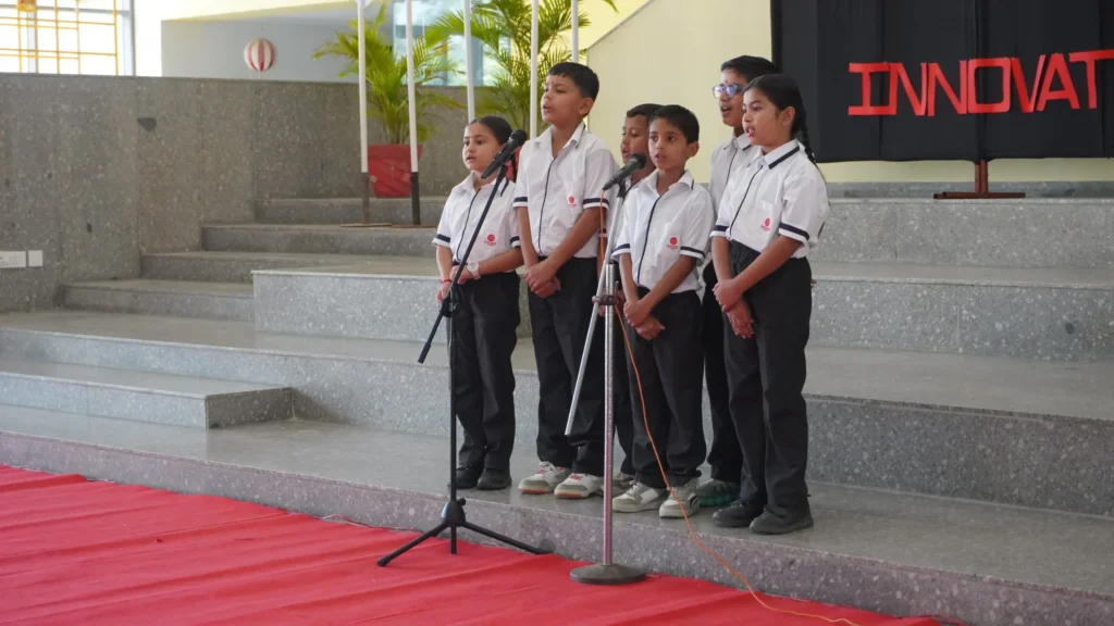 Students perform a welcome song during the Investiture Ceremony at Shree Shakti School of Innovation, showcasing their confidence and teamwork
