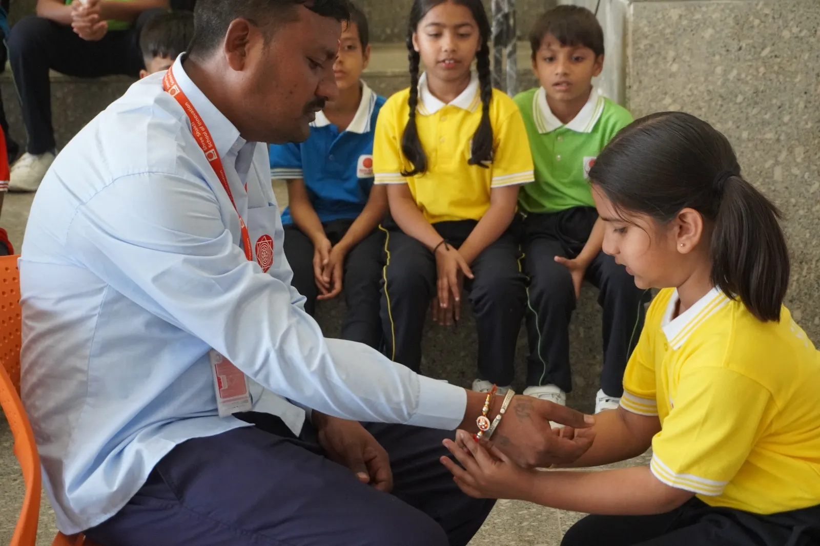 Children crafting eco-friendly seed Rakhis using natural cotton and jute in classroom