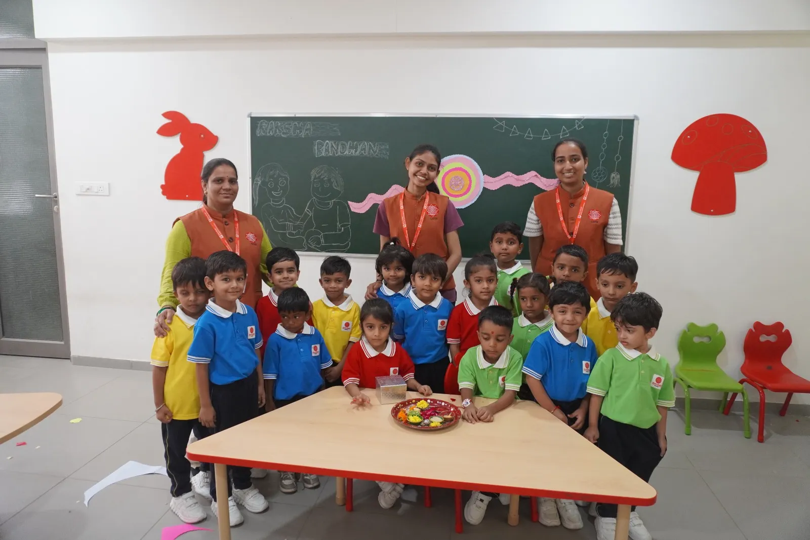 Students celebrating Rakshabandhan in classroom by tying handcrafted Rakhis