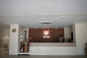 Shree Shakti School of Innovation Reception Area, Ambaji Reception area at Shree Shakti School of Innovation in Ambaji featuring a modern front desk, brick accent wall and school signage.