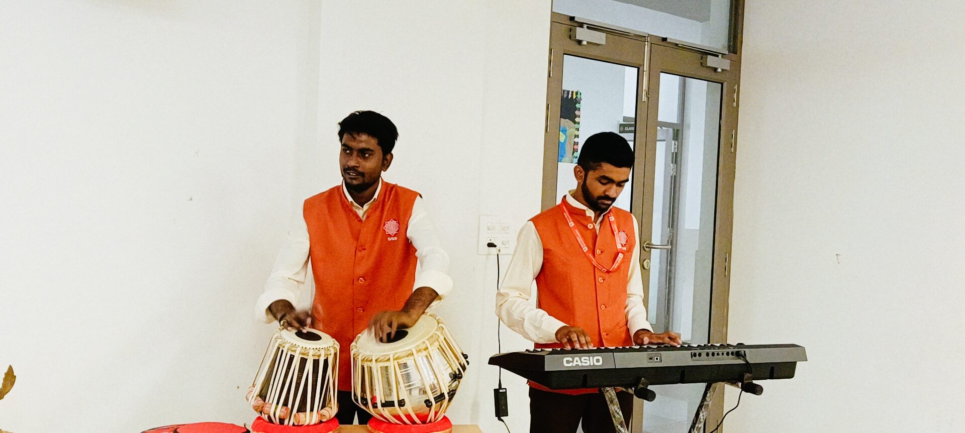 Students performing on stage during Grandparents Day cultural program at SSI Ambaji